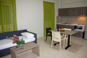 a living room with a couch and a table at Fournia Village in Kyllini
