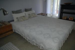 a bedroom with a large white bed with pillows at Aegina's Oasis in Egina