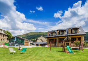 a house with a playground in the yard at Apartamentos Rurales L´Abiseu in Caboalles de Abajo