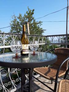 a bottle of champagne and two wine glasses on a table at Jintcharadze Inn in Makhinjauri