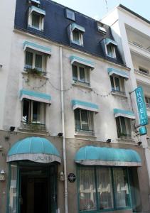 a building with blue awnings on the side of it at Hôtel Aladin in Paris