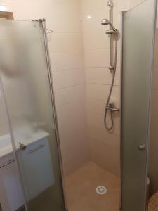 a shower with a glass door in a bathroom at The Taras unit in Eilat +17 photos