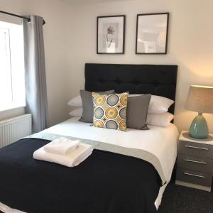 a bedroom with a bed with two towels on it at Coleman Studios in Wolverhampton