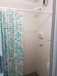 a bathroom with a shower with a shower curtain at Cana Cacum in Yerba Buena +32 photos