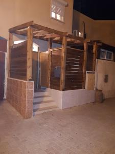 a building with wooden doors and stairs in a room at The Taras unit in Eilat