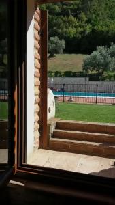 an open window with a view of stairs and grass at Agriturismo Isola Verde in SantʼUrbano