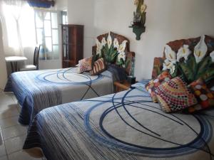Un pat sau paturi într-o cameră la Hotel Internacional Malitsin