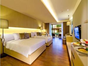 Кровать или кровати в номере Phuket Graceland Resort and Spa