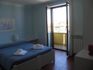 Ліжко або ліжка в номері Albergo Residence Isotta