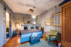 a bedroom with a blue bed and a chair at Livo Disno 12 in Split