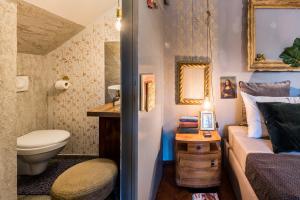 a small bathroom with a bed and a toilet in a room at Livo Disno 12 in Split