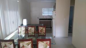 cocina con mesa, sillas y nevera en Casa em Ingleses, en Florianópolis