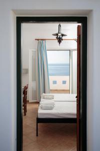 a bedroom with a bed and a view of the ocean at Villa Athina in Ambrami +203 photos