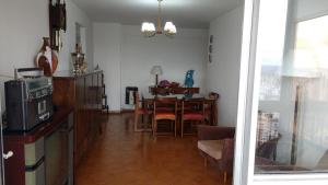 a living room with a table and a dining room at Apart frente al mar piso 32 cochera in Mar del Plata
