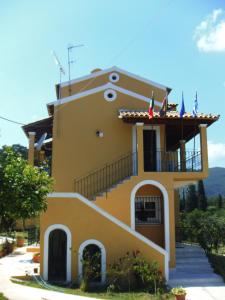 a house with two flags on top of it at Niki Apartments in Ipsos