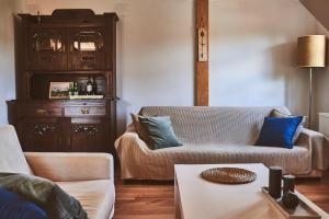 a living room with two couches and a table at Karolina in Polanica-Zdrój