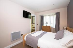 a bedroom with a bed and a flat screen tv at Riverview Apartment in Durham