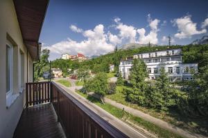 a balcony with a view of a street and buildings at Vyhliadka Galfy in Starý Smokovec