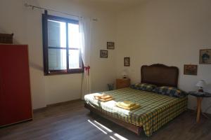 a bedroom with a bed and a window at La Quercia Agriturismo in Imperia