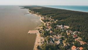an aerial view of a small island in the water at Apartamentai Juodkranteje in Juodkrantė