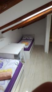 a room with two bunk beds and a table at Istrian Sunrise in Koper