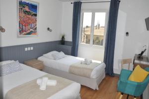Un ou plusieurs lits dans un hébergement de l'établissement Hotel Cote Basque