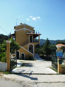 a house with a gate in front of it at Niki Apartments in Ipsos