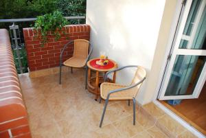 a small table and two chairs on a balcony at Kasztanowa Apartament in Warsaw +15 photos