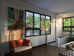 a room with a chair and some windows at Balay 8 Suites in Silay