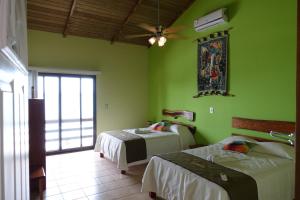 Postel nebo postele na pokoji v ubytování Hotel Bahia Taitza