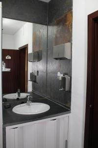 a bathroom with a sink and a mirror at Casa da Muralha Suíte in Monsaraz +14 photos