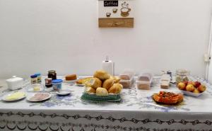 a table with bread and other foods on it at Pousada Parque Ecológico in Indaiatuba