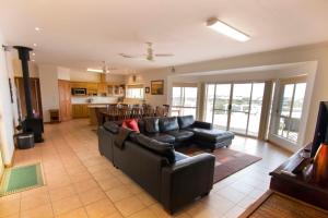 a living room with a couch and a kitchen at Limestone Ridge in Tailem Bend