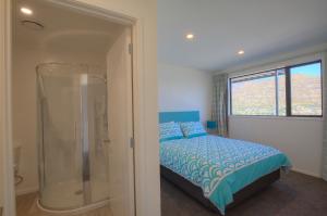sypialnia z kabiną prysznicową i łóżkiem w obiekcie Views from the Tiers w mieście Queenstown