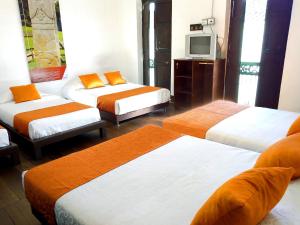 Postel nebo postele na pokoji v ubytování Raices Hotel San Agustin