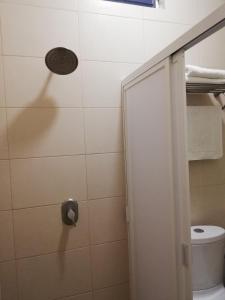 a bathroom with a shower with a toilet at Hotel Nonni in Santa Cruz Huatulco