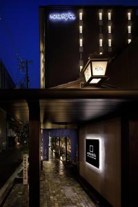two photos of a building at night with a street at Hotel Resol Kyoto Kawaramachi Sanjo in Kyoto