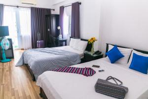 Postel nebo postele na pokoji v ubytování Blue Star Hotel