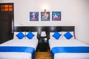 Postel nebo postele na pokoji v ubytování Blue Star Hotel