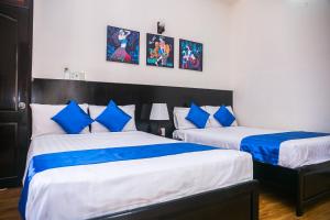 Postel nebo postele na pokoji v ubytování Blue Star Hotel