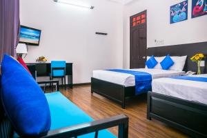 Postel nebo postele na pokoji v ubytování Blue Star Hotel