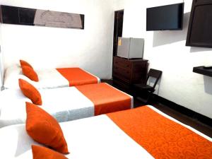 Tempat tidur dalam kamar di Raices Hotel San Agustin