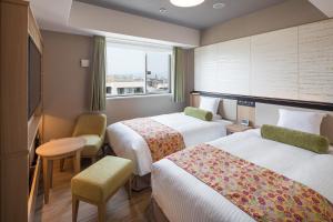 Postel nebo postele na pokoji v ubytování HOTEL MYSTAYS Kyoto Shijo