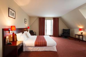 En eller flere senge i et værelse på Hotel Restaurant Weinebrugge