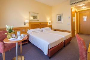 Postel nebo postele na pokoji v ubytování Best Western Hotel I Triangoli