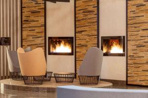 a lobby with four chairs and fireplaces at Best Western Vib Antalya Hotel in Dosemealti