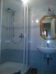 a bathroom with a shower and a sink and a tub at Hotel Drei Kronen in Tecklenburg