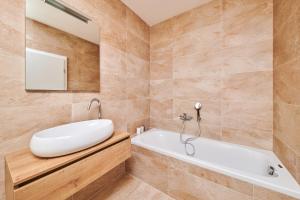 a bathroom with a white tub and a sink at Ribarska Koliba - Villa Marija in Pula +32 photos