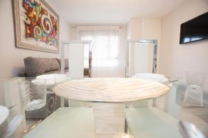 a living room with a table and some chairs at Center Deluxe in Granada