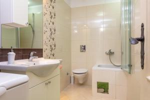 a bathroom with a sink and a toilet and a shower at Villa Mama - Traditional Apartments in Omis, free parking in Omiš +40 photos